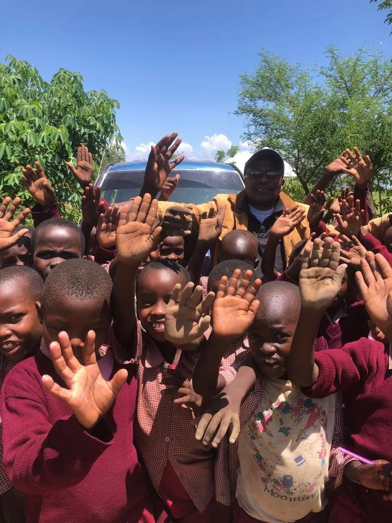 Children gathered outdoors at a TACHIP program site in Tanzania