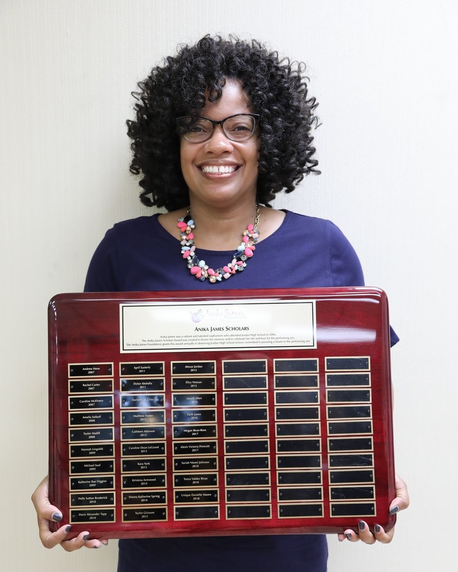 Jordan High School Principal Susan Taylor with the Anika James Scholars plaque